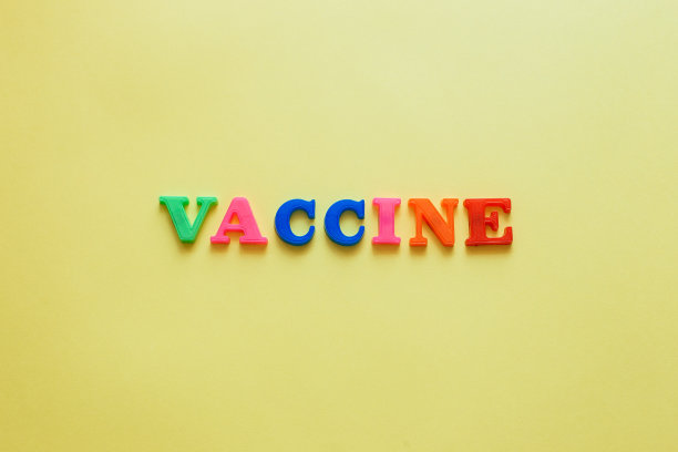 黄色背景上的“疫苗”一词图片下载