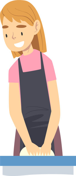 穿着围裙的微笑女孩在厨房做饭图片下载