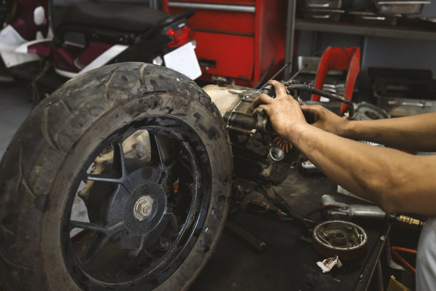 摩托车车轮修理的特写与软焦点和在背景过光图片下载