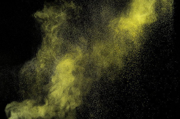 黑色背景上的金粉爆炸。图片下载