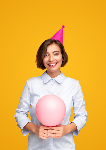 戴着气球和派对帽的快乐女性图片下载