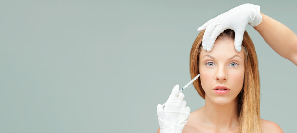 年轻女子用医生的手注射肉毒杆菌图片下载