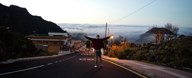 一个男人在日出时走在街上的概念性照片。图片下载