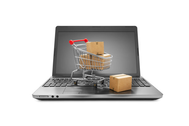 购物车里的盒子放在笔记本电脑键盘上图片下载