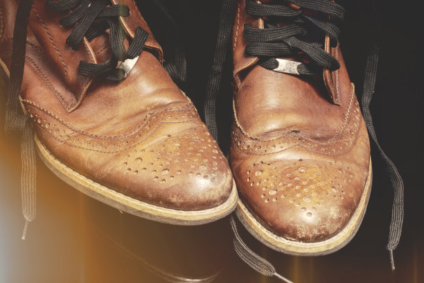 一双棕色的复古皮鞋被黄色的灯光照亮。漂亮的皮鞋。图片下载