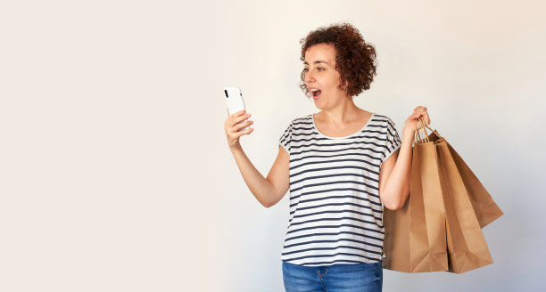 在一个孤立的白人社区用智能手机在线购物时，一名女性脸上带着惊讶图片下载
