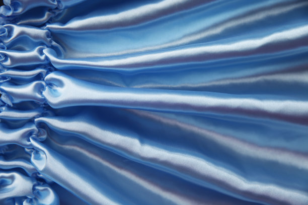 蓝色丝织的波浪褶皱，抽象的背景图片下载