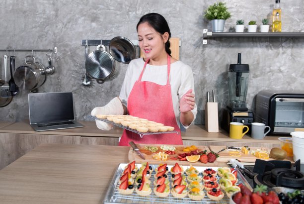 亚洲妇女使水果挞网上销售在家图片下载