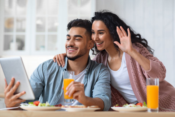 现代穆斯林夫妇在厨房里用平板电脑进行视频通话图片下载