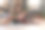 水平完整的照片，美丽的年轻女子坐在地板上靠在她的男朋友的背上，帮助他做伸展运动图片下载