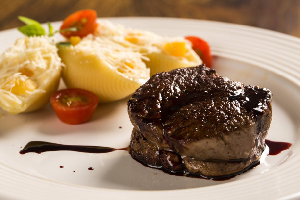 烤海螺配白软干酪和牛排装盘。图片下载