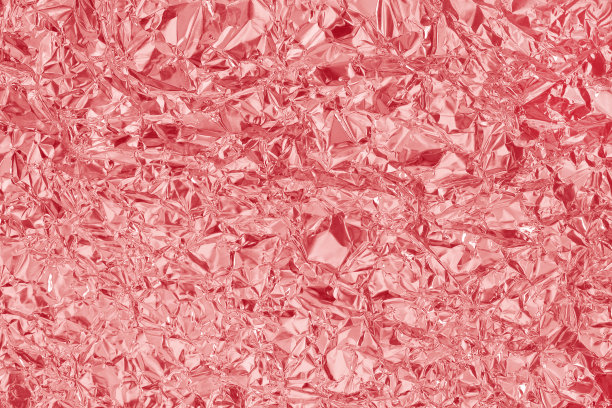 闪亮的玫瑰金箔纹理背景，皱巴巴的粉红色包装纸图案。图片下载