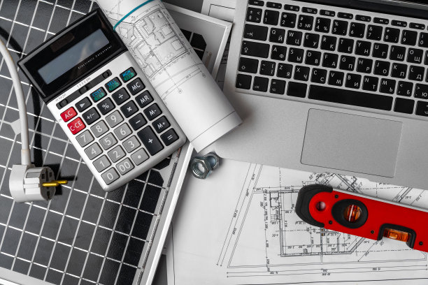 桌子上有建筑蓝图和太阳能电池板图片下载