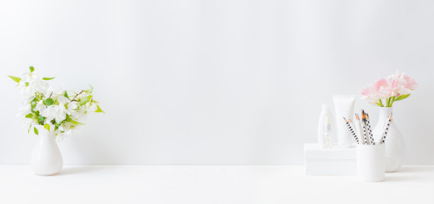 家庭内部装饰元素。粉红色的郁金香插在花瓶上，在浅色的背景上，化妆套装图片下载