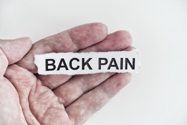 一个男人手里拿着一张写着“背痛”的纸图片下载