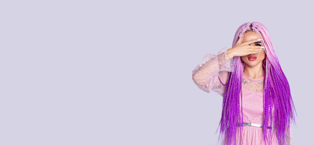 横幅,长格式。照片上，一个皮肤白皙、头发粉红的女孩透过手指看过去，静静地孤立在灰色的背景上。图片下载