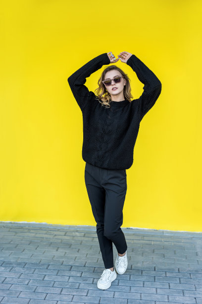 时尚的肖像漂亮的女士近黄色的墙图片下载