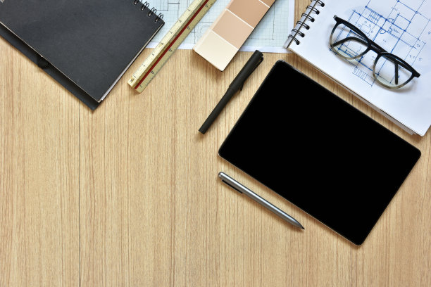 建筑师办公桌的俯视图，上面有用于绘图的钢笔在木桌上勾画出的想法，现代技术的概念是用写字板进行建筑工作图片下载