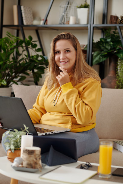 年轻女子用手提电脑工作图片下载