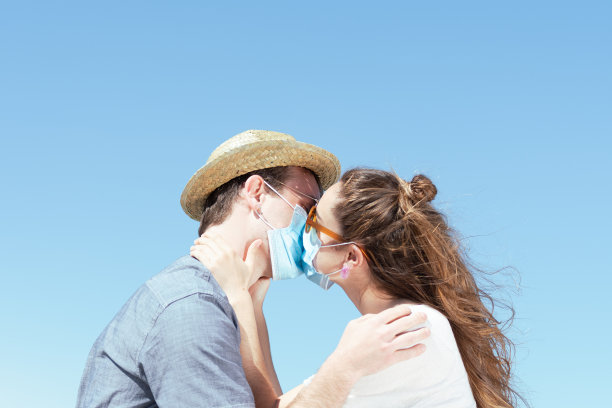冠状病毒大流行期间戴口罩接吻的情侣图片下载
