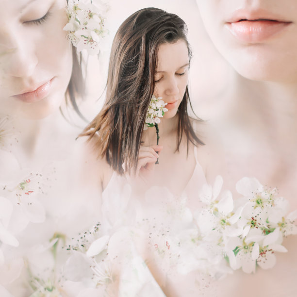 年轻美丽的女子手持白色背景上的鲜花。温柔的纯粹的肖像。面部护肤健康，自然妆容。图片下载