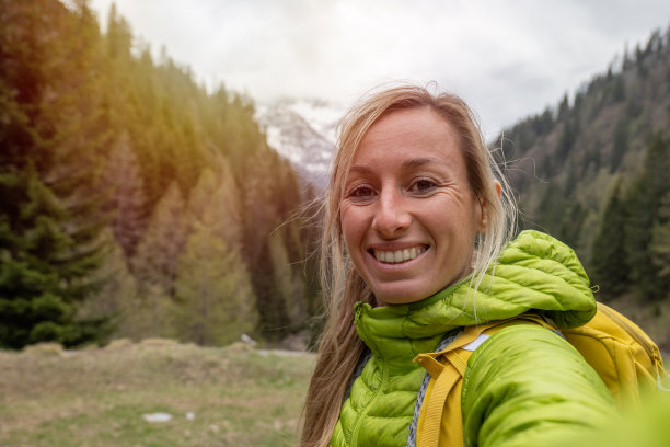 在山里徒步旅行的年轻女子在自拍图片下载