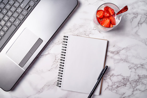 打开笔记本电脑，空白的笔记本和一杯健康的酸奶和新鲜的切片草莓在桌子上，拷贝空间。自由职业者工作空间，家庭办公室。俯视图，平放图片下载