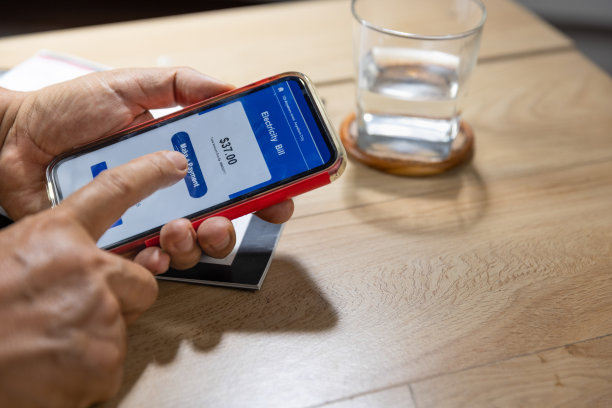 困惑的老男人的手正在用手机付电费图片下载