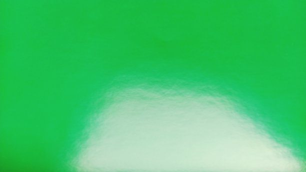 亮绿色的纸。背景图片下载