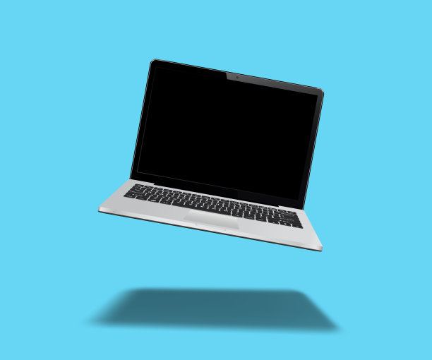 笔记本电脑漂浮在蓝色背景上图片下载