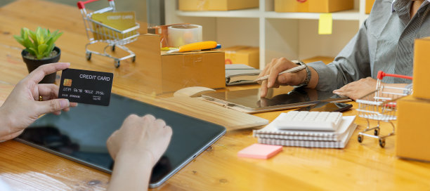 小企业主在工作中使用笔记本电脑和电话，移动和纸板箱，小企业主，中小企业在家里使用盒子，在网上销售，电子商务。图片下载