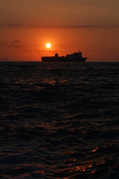 日落时漂浮的船。图片下载