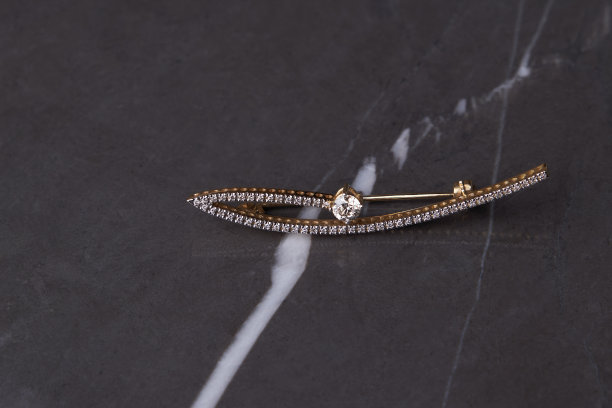 粉彩丝绸背景上的钻石胸针，特写。图片下载