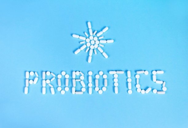 益生菌字和太阳药丸在蓝色的背景图片下载