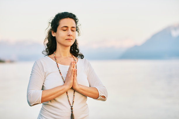 美丽的精神女人，穿着白色的衣服，在湖边沉思图片下载
