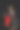 一位穿着黑色连衣裙的年轻女子高兴地拿着一份礼物，在黑色和红色的袋子里购物。在一个孤立的黑色背景上图片下载