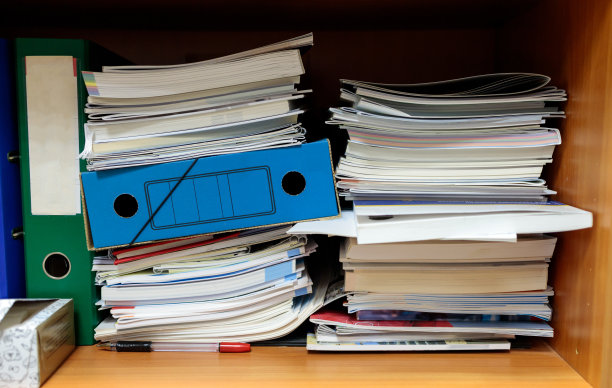 在壁橱里，硬纸板文件夹和杂志堆放在一起图片下载