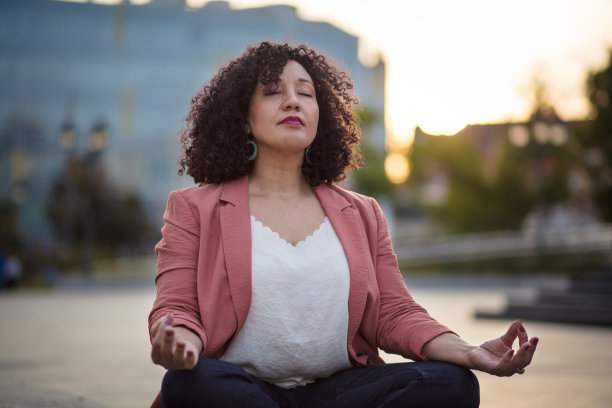 在街上练瑜伽的女商人。图片下载