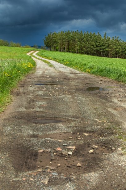 通往暴风雨的道路。捷克共和国的乌云和土路。捷克乡村春天的暴风雨天气。图片下载
