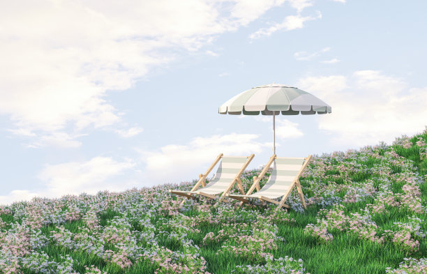 春花田野景象与沙滩椅和伞。图片下载