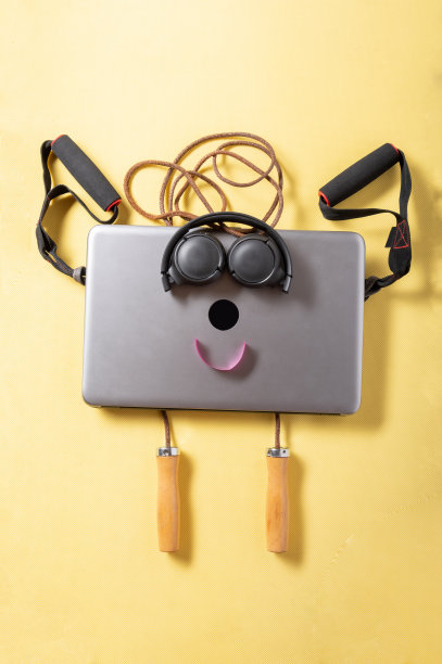 使用笔记本电脑在线学习。在线体育。笔记本电脑和跳绳。黄色背景。图片下载