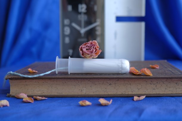 更年期的概念。干红玫瑰躺在妇女卫生棉条上。图片下载