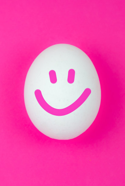 粉红色背景上带着微笑的白色鸡蛋。积极的思考。所有的都很好。副本的空间。极简主义，原创和创意的照片。漂亮的壁纸。复活节假期。图片下载