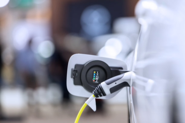 电动汽车充电站。混合动力汽车电动充电站在停车场。电动汽车在停车场和充电站充电。电插座。交通电动汽车图片下载