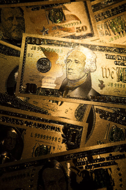 货币美国黄金美元钞票特写背景。图片下载