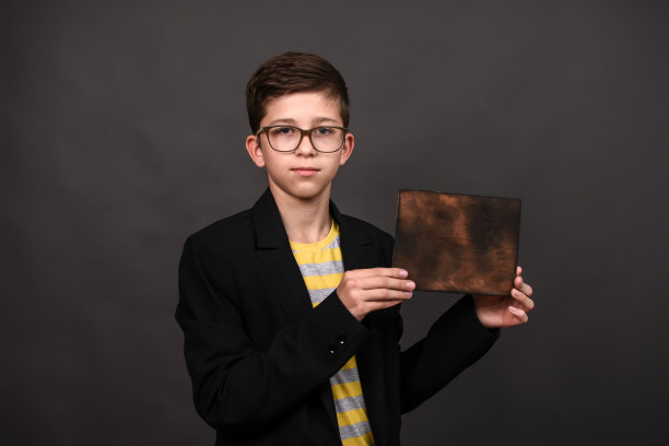 一个男孩手中的老式木板。模拟了图片下载