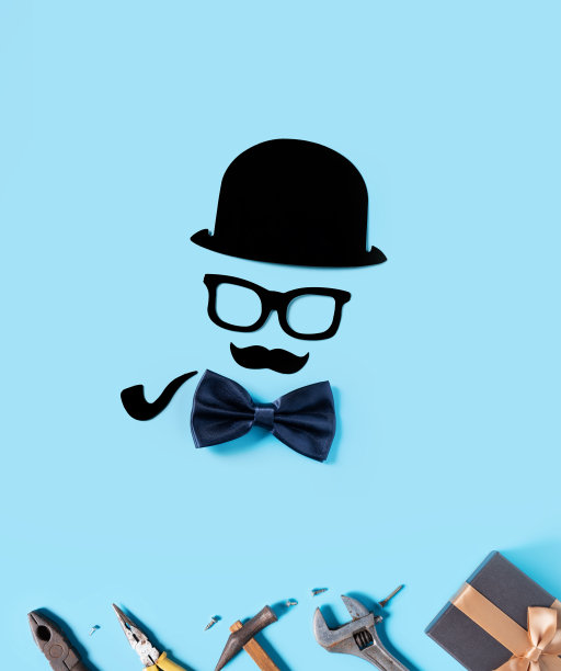 父亲节背景设计理念。蓝色桌面背景上的纸张装饰和工作工具的俯视图。图片下载