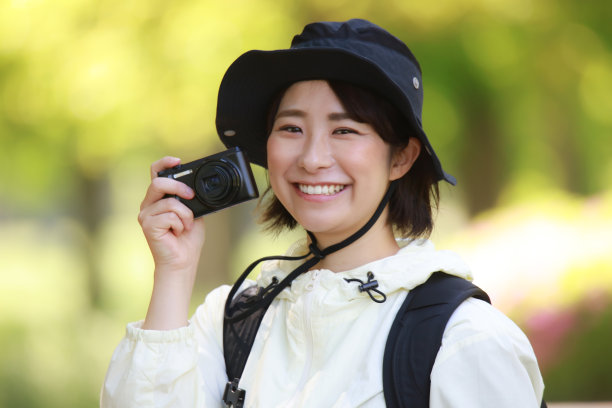 这是一个女人带着数码相机爬山的照片图片下载