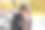 一个小男孩坐在滑板场的斜坡上，他的自行车轮子放在身后。那家伙骑完马，从头上摘下了一个黑色的头盔，从脖子下解开图片下载