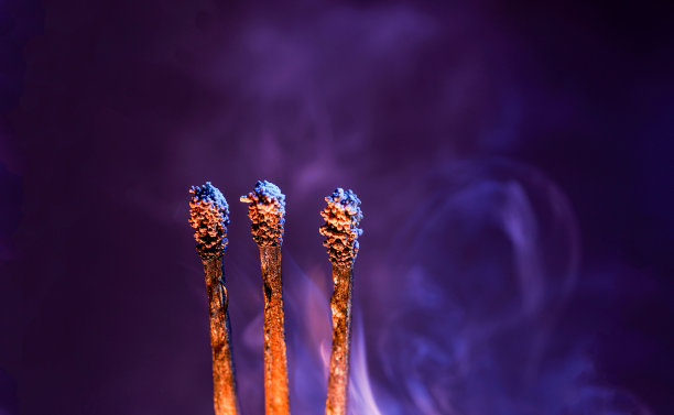 点燃火柴，在摄影棚里熄灭后，用彩色的箔纸在闪光灯前拍照图片下载